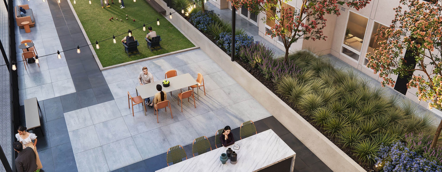 Outdoor courtyard at Broadstone Saratoga Apartments in Boise, ID, featuring a BBQ area with a marble island, dining tables, bocce court, and lounge seating. Surrounded by lush landscaping and string lights, creating an inviting community space for residen