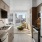 Sleek apartment kitchen at Broadstone Saratoga featuring wood cabinetry, tile backsplash, stainless steel appliances, and open living space with city views.