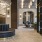 Elegant lobby entrance at Broadstone Saratoga with a modern desk, decorative lighting, and a spacious seating area