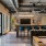 Spacious game room at Broadstone Saratoga featuring a foosball table, pool table, bar seating, and exposed brick accent wall with modern lighting.