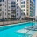 Broadstone Saratoga pool surrounded by residential buildings, string lights, and seating