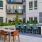 Outdoor courtyard at Broadstone Saratoga with BBQ station, dining tables, and a game area
