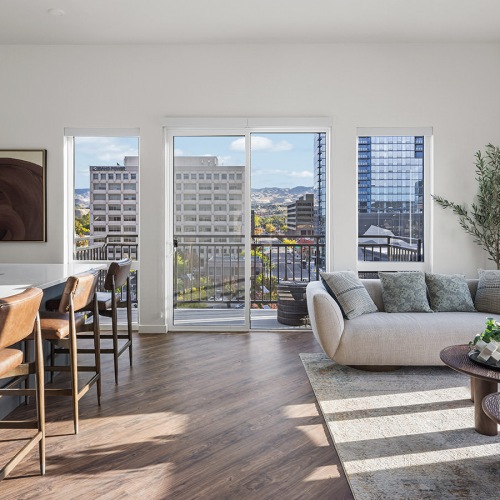 sunlit living room with access to private balcony