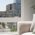 a chair near a large window overlooking a city