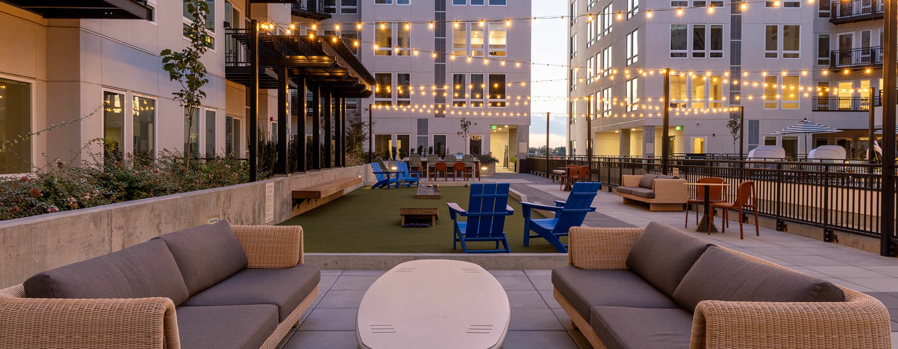 Outdoor courtyard at Broadstone Saratoga Apartments in Boise, ID, featuring  a  bocce court, and lounge seating.