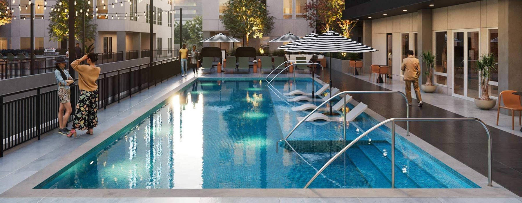 outdoor pool area with lounge chairs, in-pool loungers, and striped umbrellas surrounded by string lights and greenery